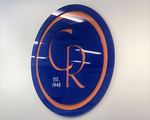 A large CR logo hanging on a wall.